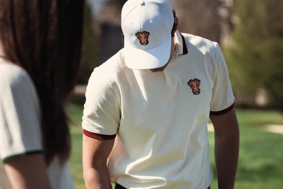 Cream polo worn tucked into golf trousers