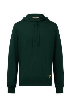 Hoodie Dogleg Clubhouse homme vert foncé porté par un golfeur — hoodie cachemire, golf Suisse